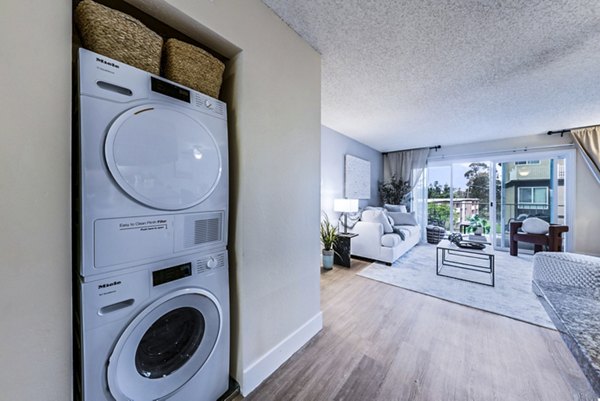 Modern laundry room with energy-efficient washers and dryers at Harbor Park Apartments, a Greystar luxury community