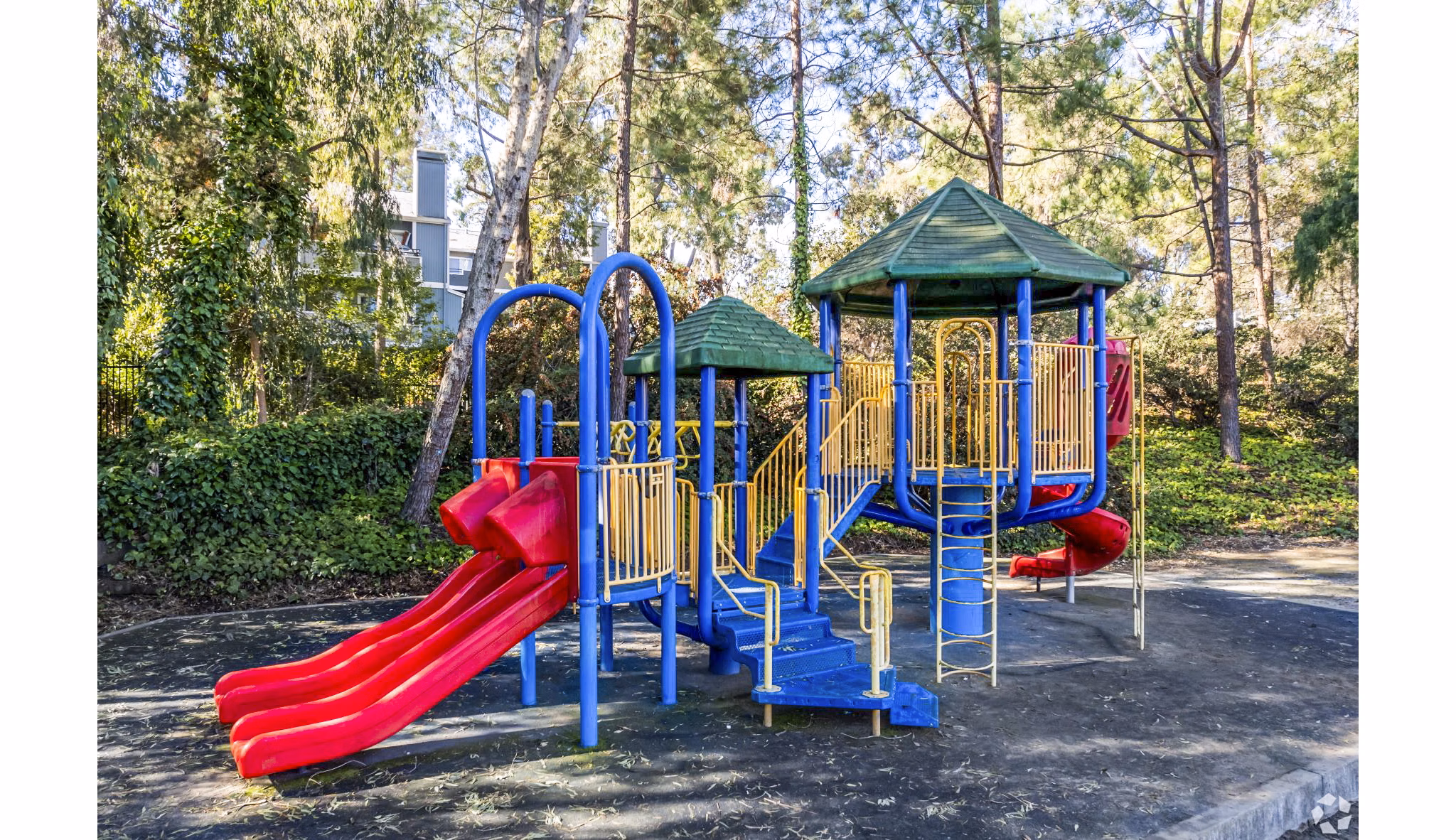 Modern playground with slides and swings at Harbor Park Apartments