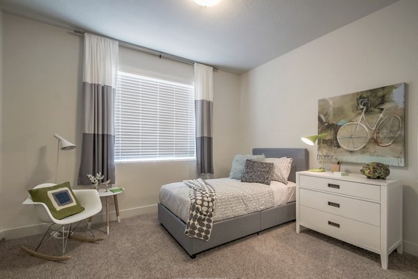 Spacious bedroom with large windows and modern decor at One West Apartments Perfect for luxury living and comfort seekers alike