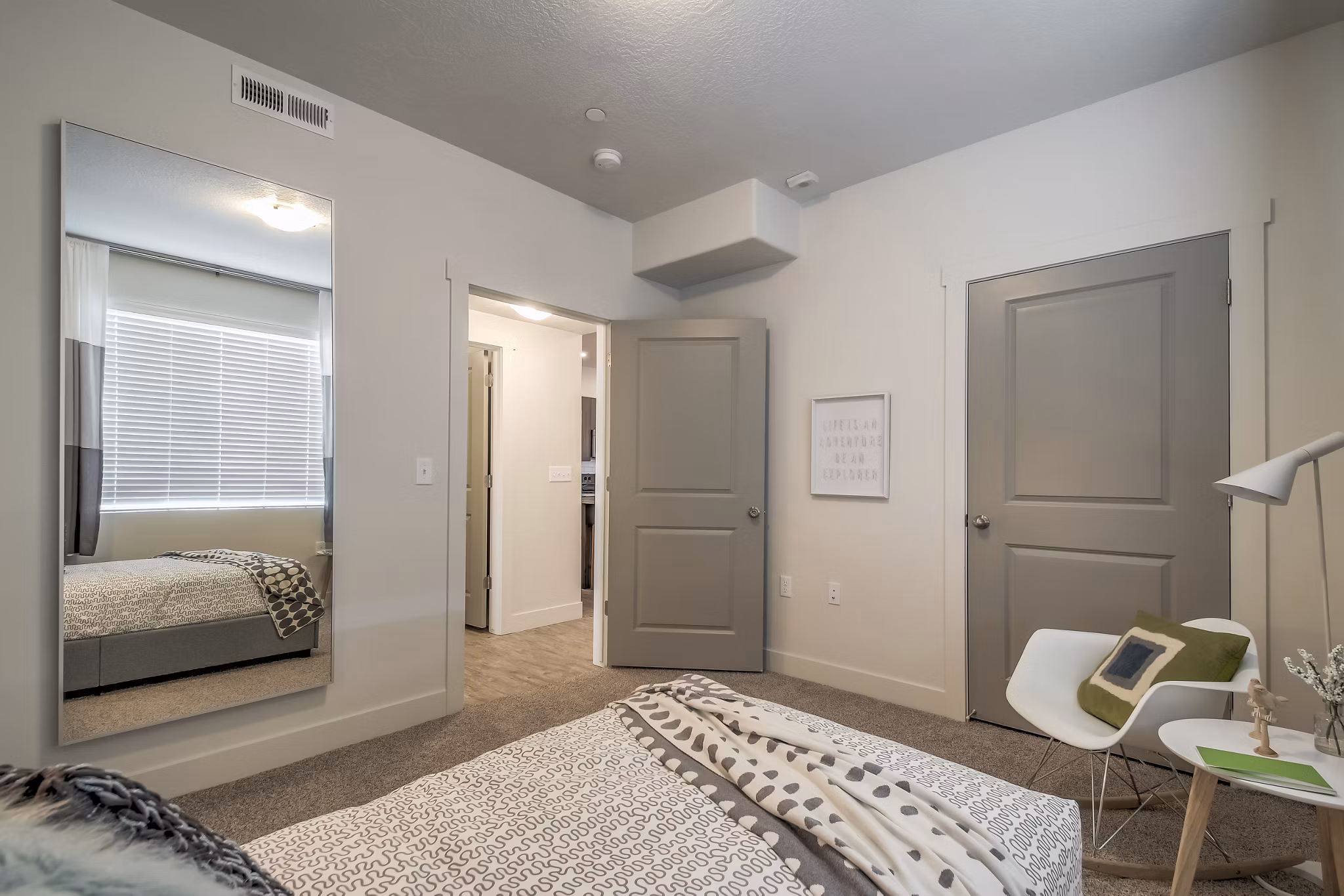 Modern bedroom at One West Apartments featuring elegant design and luxury furnishings