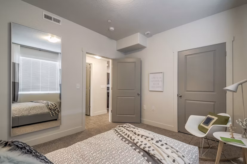 Modern bedroom at One West Apartments featuring elegant design and luxury furnishings