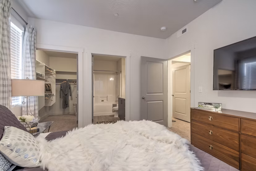 Modern bedroom with cozy design at One West Apartments