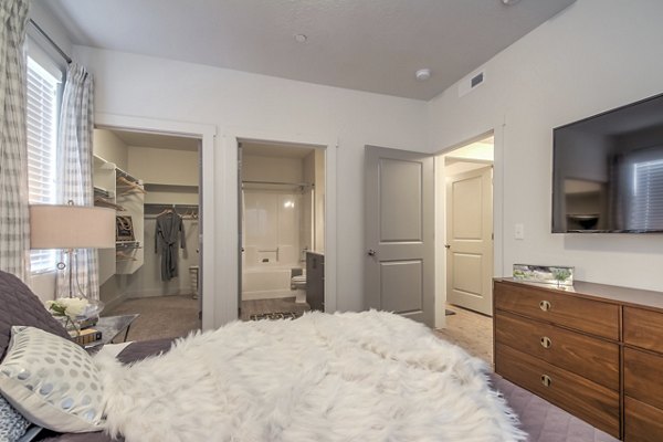Modern bedroom with cozy design at One West Apartments