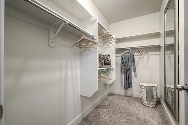 Cozy bedroom with modern decor and plush bedding at One West Apartments