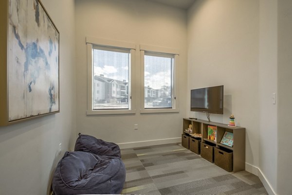 Modern clubhouse with lounge seating and pool table at One West Apartments, a luxury living community