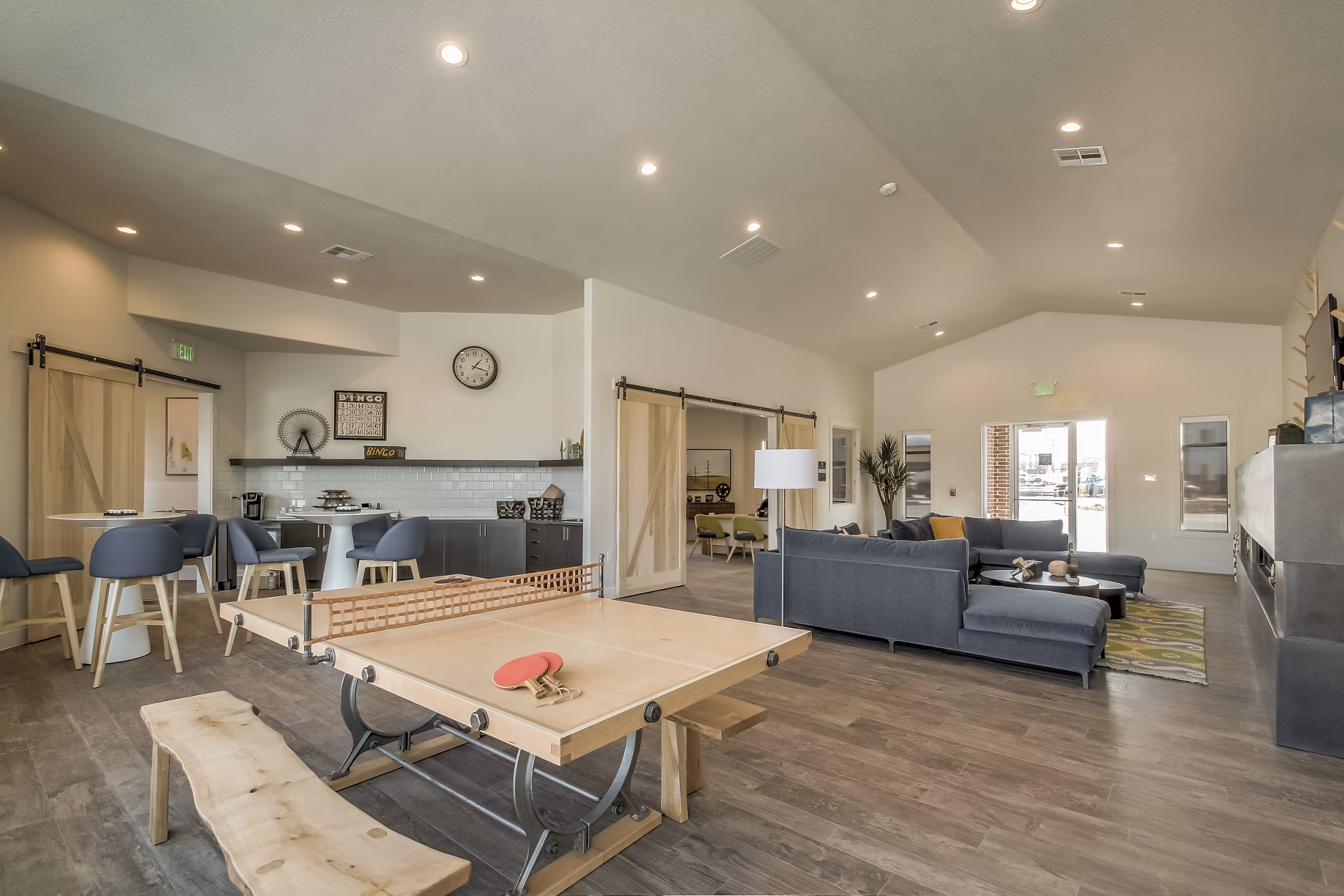Game room with pool table and lounge seating at One West Apartments Enjoy luxury amenities and community spaces designed for entertainment and relaxation