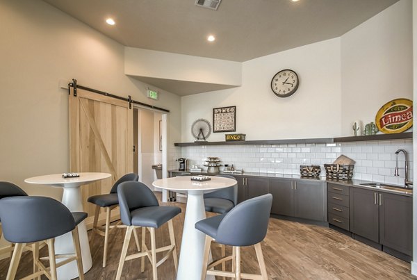 Modern clubhouse featuring cozy seating and a pool table at One West Apartments