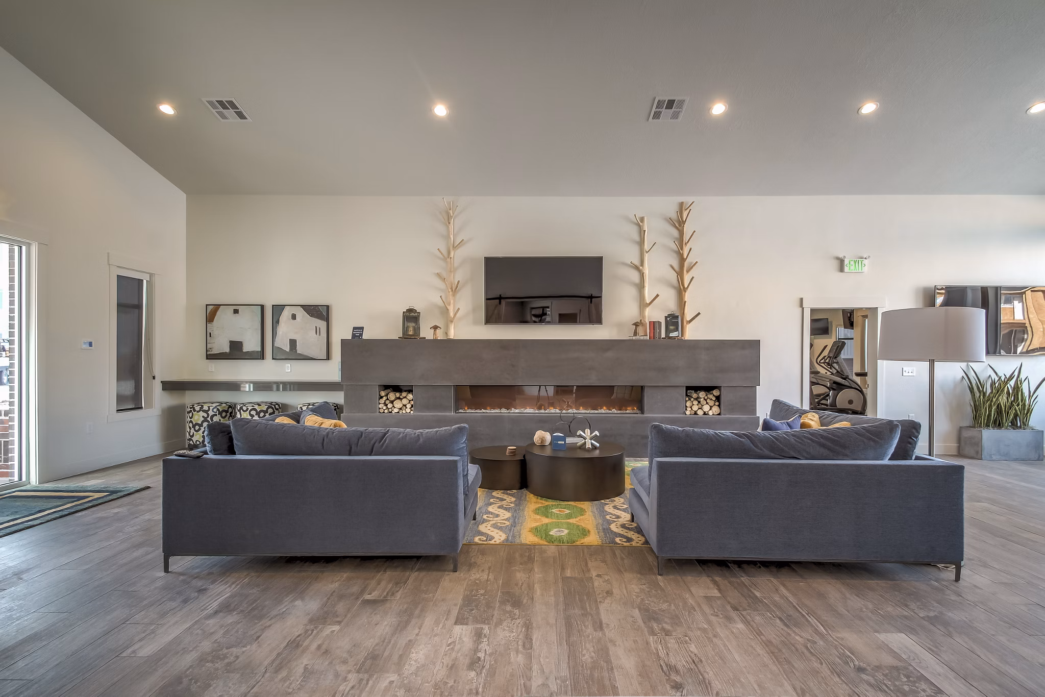 Upscale clubhouse featuring modern design and cozy seating areas at One West Apartments in West Haven, UT.