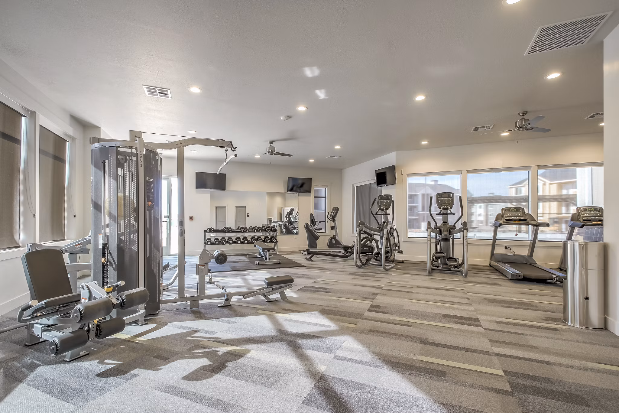 Modern fitness center with state-of-the-art equipment at One West Apartments