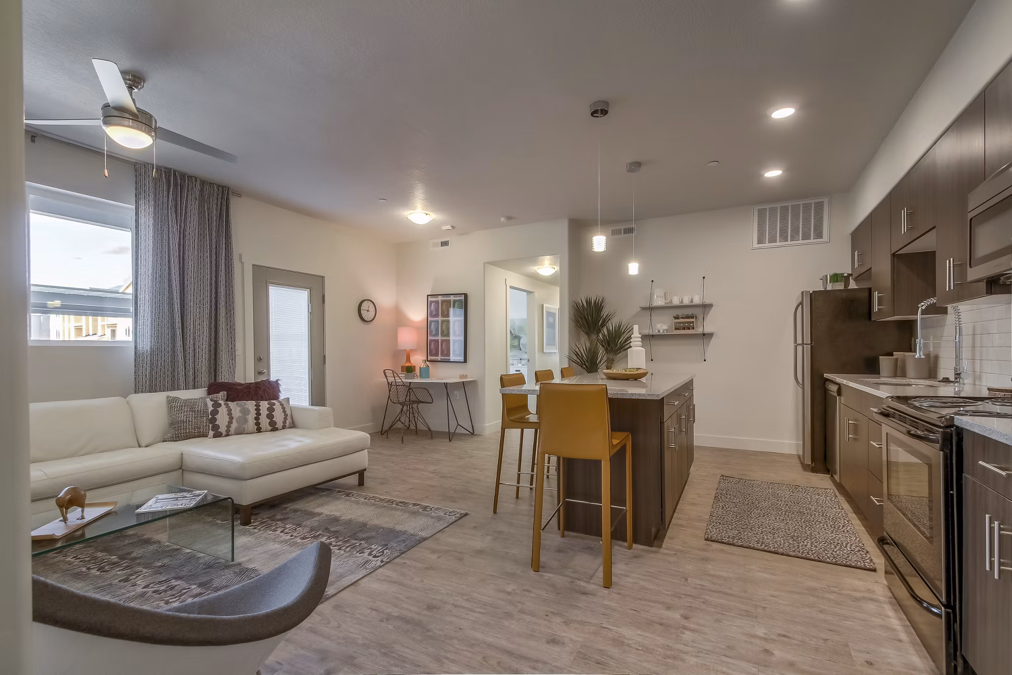 Modern kitchen with stainless steel appliances at One West Apartments
