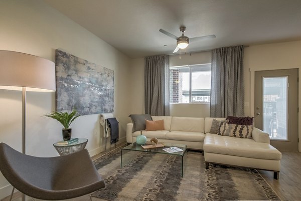 Spacious living room with modern decor at One West Apartments, luxury Greystar property