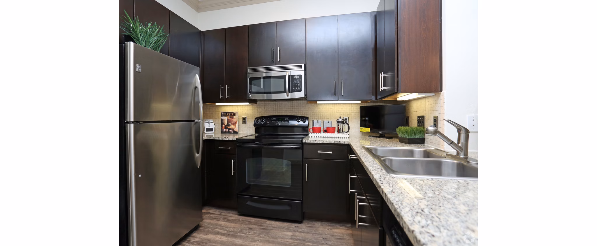 Braeswood Place Apartments: Modern kitchen featuring stainless steel appliances and granite countertops