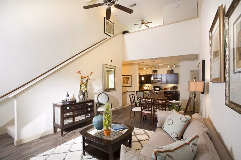 Modern living room with plush seating and bright decor at Braeswood Place Apartments