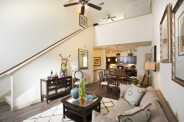 Modern living room with plush seating and bright decor at Braeswood Place Apartments