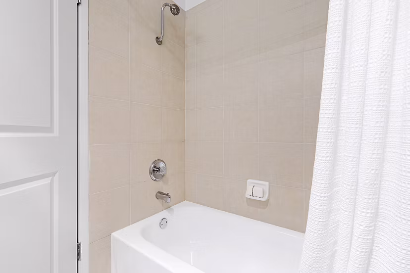 Luxurious bathroom featuring a modern bathtub and walk-in shower in Greystar luxury apartments