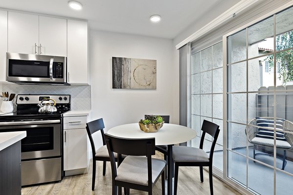 Spacious dining area with modern lighting in The Franciscan Apartments