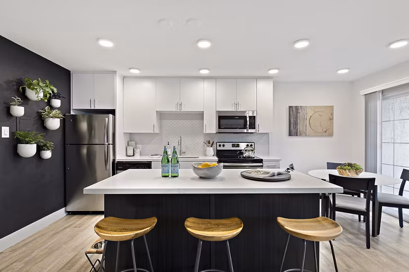 Modern kitchen with stainless steel appliances at The Franciscan Apartments