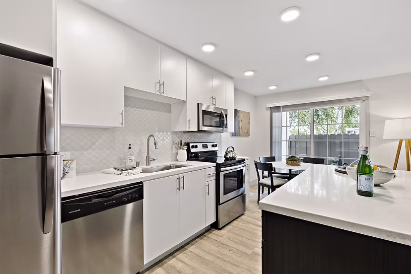Modern kitchen with stainless steel appliances at The Franciscan Apartments