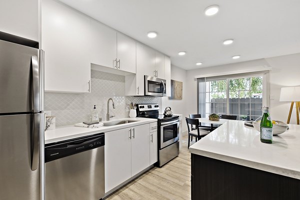 Modern kitchen with stainless steel appliances at The Franciscan Apartments
