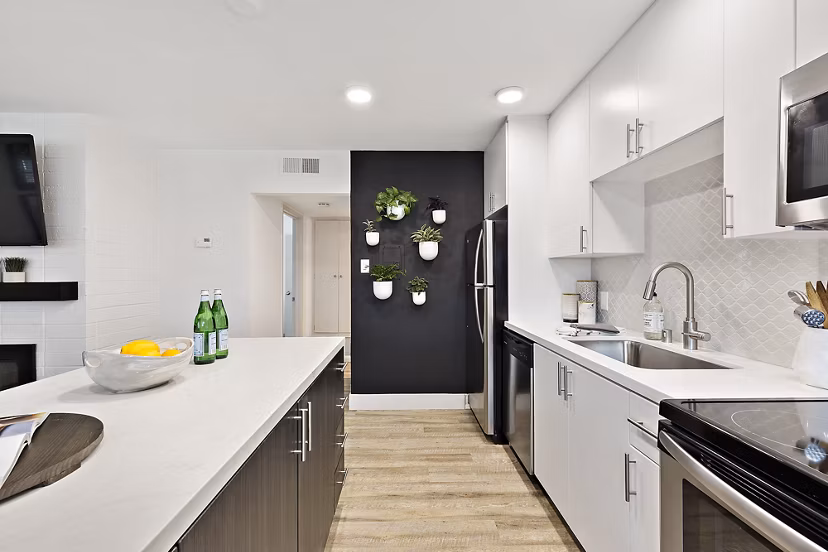 Beautiful wooden cabinetry and stainless steel appliances in a modern kitchen at The Franciscan Apartments