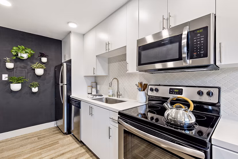 Modern kitchen with stainless steel appliances at The Franciscan Apartments