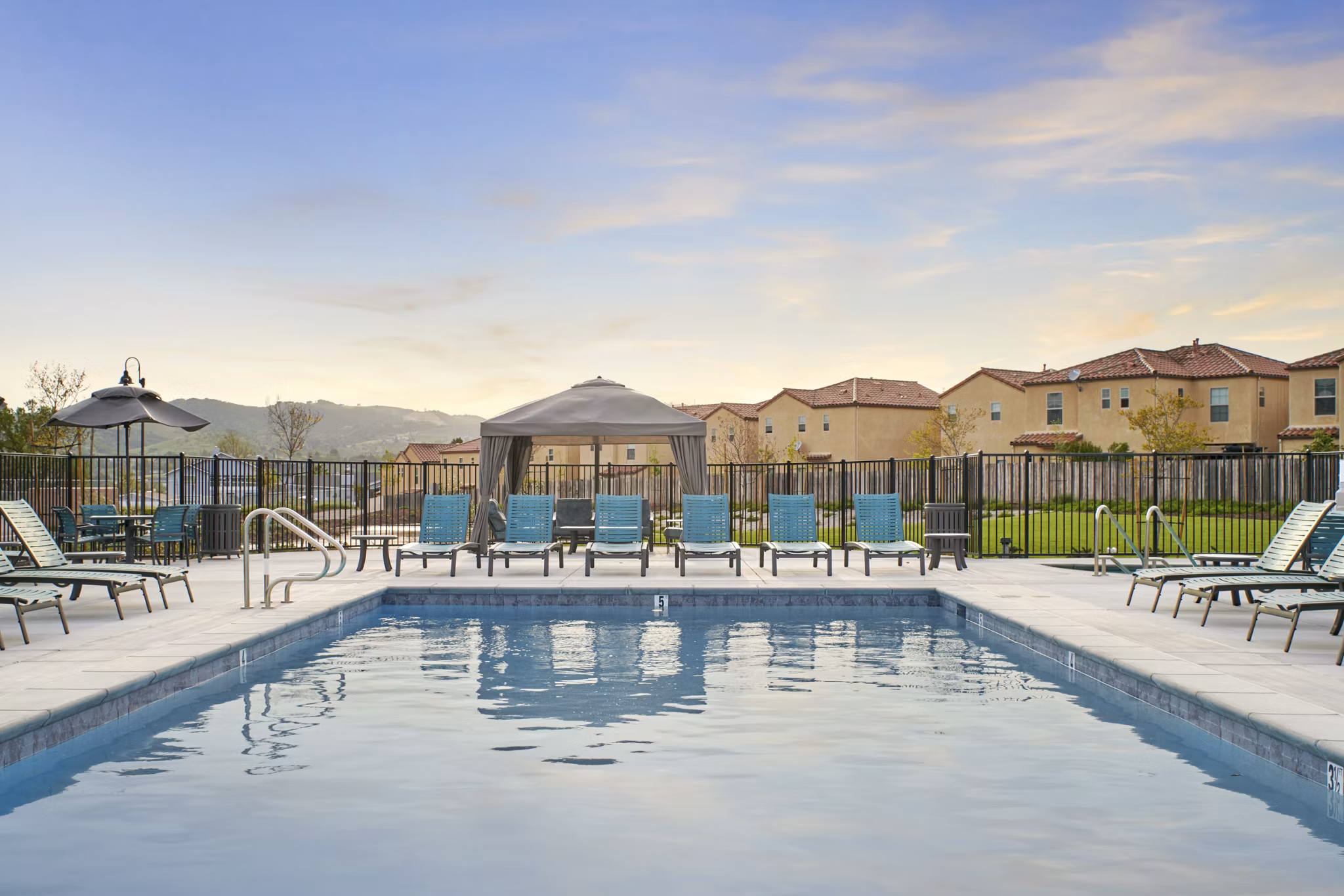 Relaxing pool area with loungers at Blue Oak Apartments luxury Greystar community