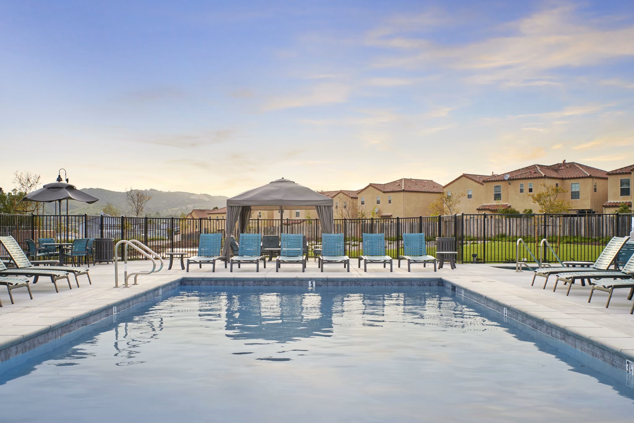Relaxing pool area with loungers at Blue Oak Apartments luxury Greystar community