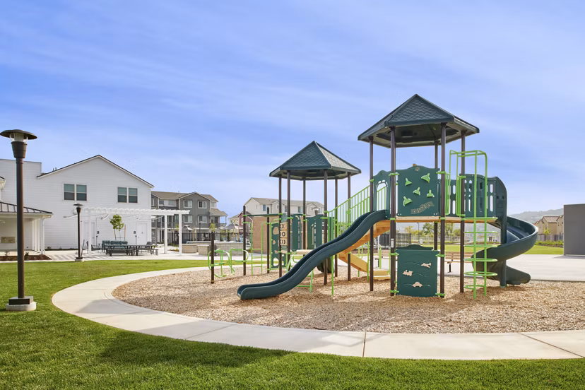 Modern playground with slides and climbing equipment at Blue Oak Apartments, a luxury living community
