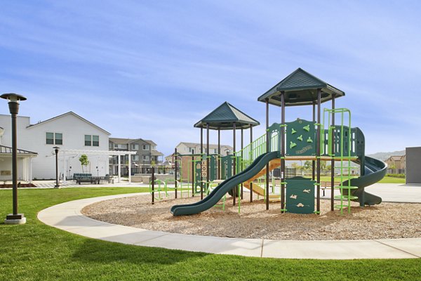 Modern playground with slides and climbing equipment at Blue Oak Apartments, a luxury living community