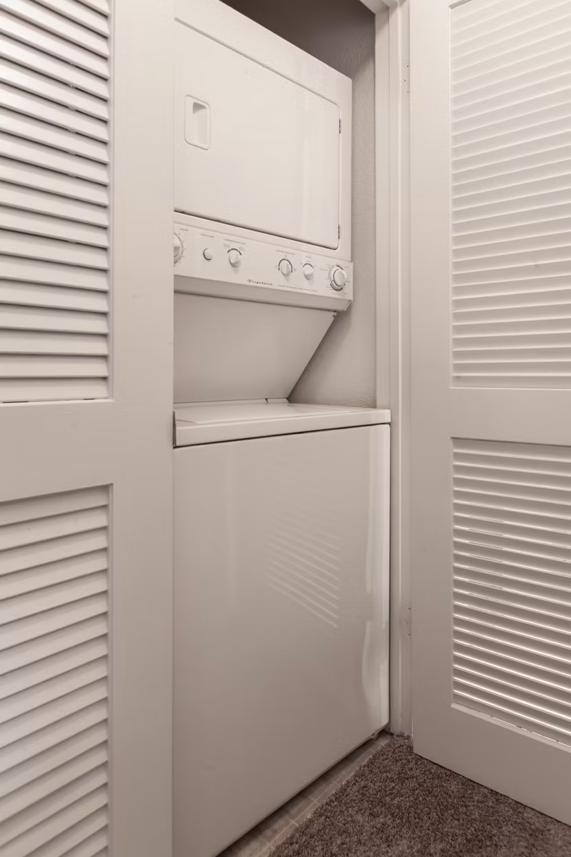 Laundry room with modern appliances at Monte Vista Apartments offering convenient on-site facilities for residents