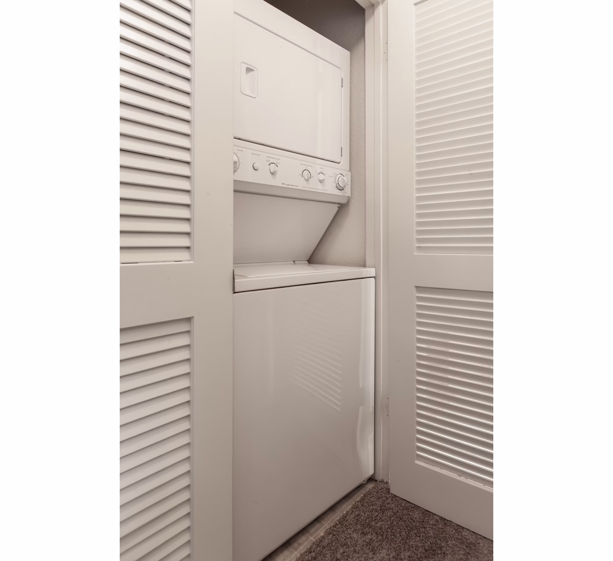 Laundry room with modern appliances at Monte Vista Apartments offering convenient on-site facilities for residents