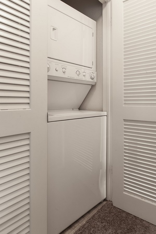 Laundry room with modern appliances at Monte Vista Apartments offering convenient on-site facilities for residents