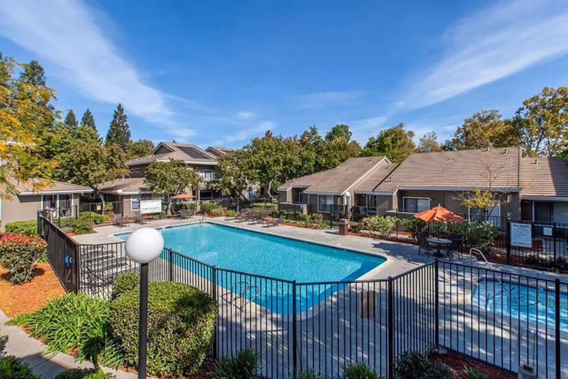 Outdoor pool with lounge chairs at Monte Vista Apartments offering relaxation and leisure