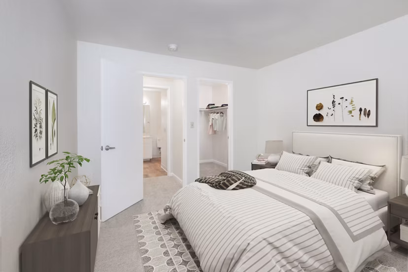 Cozy bedroom with modern decor in Brookside Apartments, featuring wood flooring and natural light