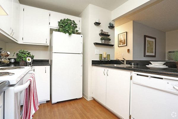 Modern kitchen with marble countertops and stainless steel appliances at Brookside Apartments, a luxury Greystar property