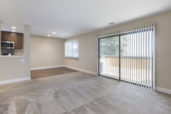 Living room with modern decor and large windows at Mission Pines luxury apartments