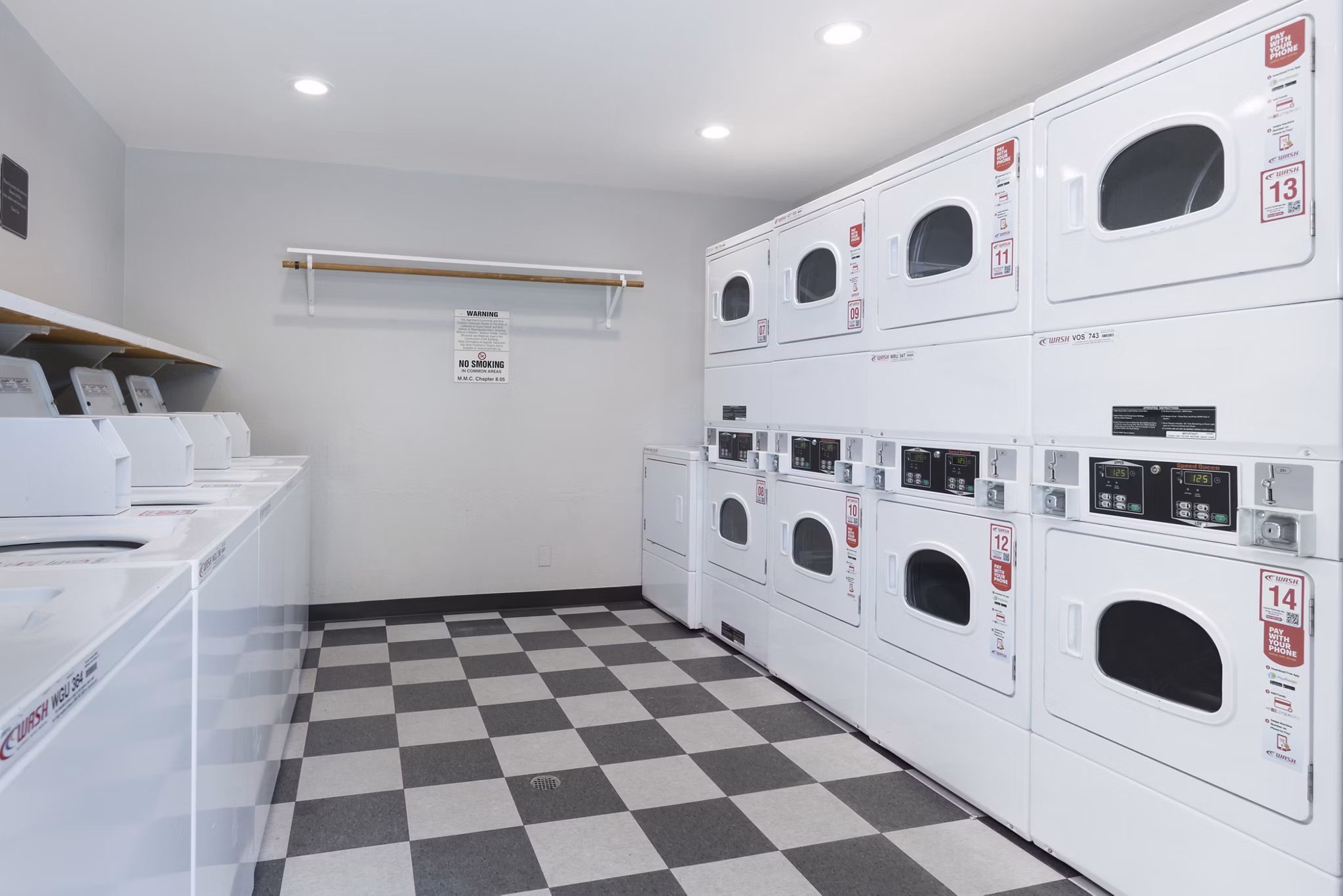 Laundry facility featuring high-efficiency washers and dryers at Mission Pines luxury apartments