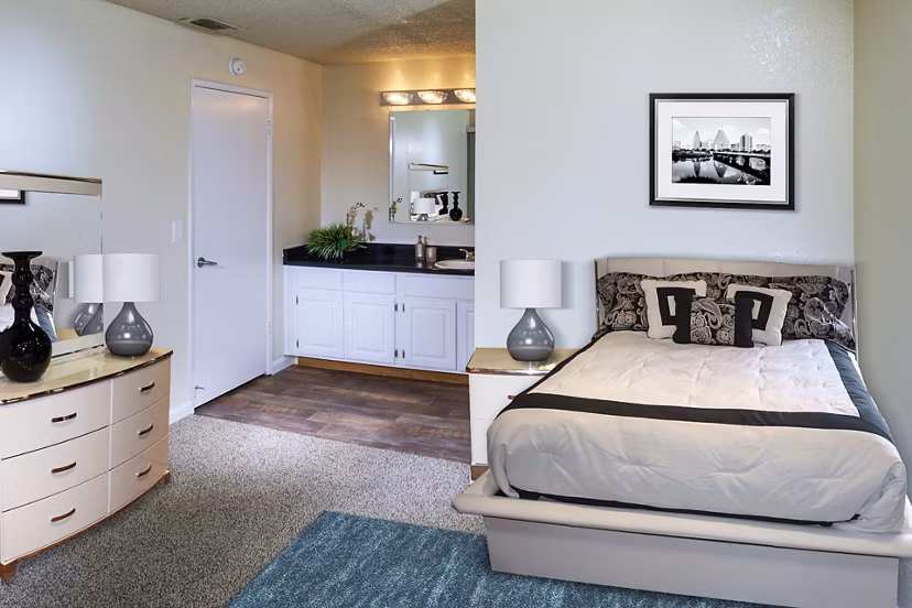Cozy bedroom with modern decor at Vista Oaks Apartments featuring luxury bedding and soft lighting for a relaxing atmosphere