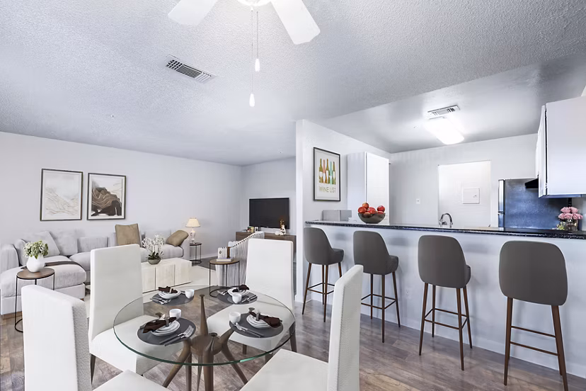 Dining area with modern furnishings and large windows in Vista Oaks Apartments
