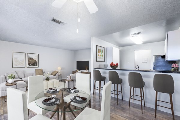 Dining area with modern furnishings and large windows in Vista Oaks Apartments