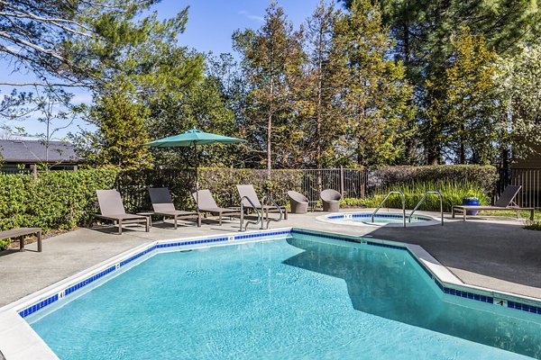 Relaxing outdoor pool area at Vista Oaks Apartments providing luxury leisure amenities