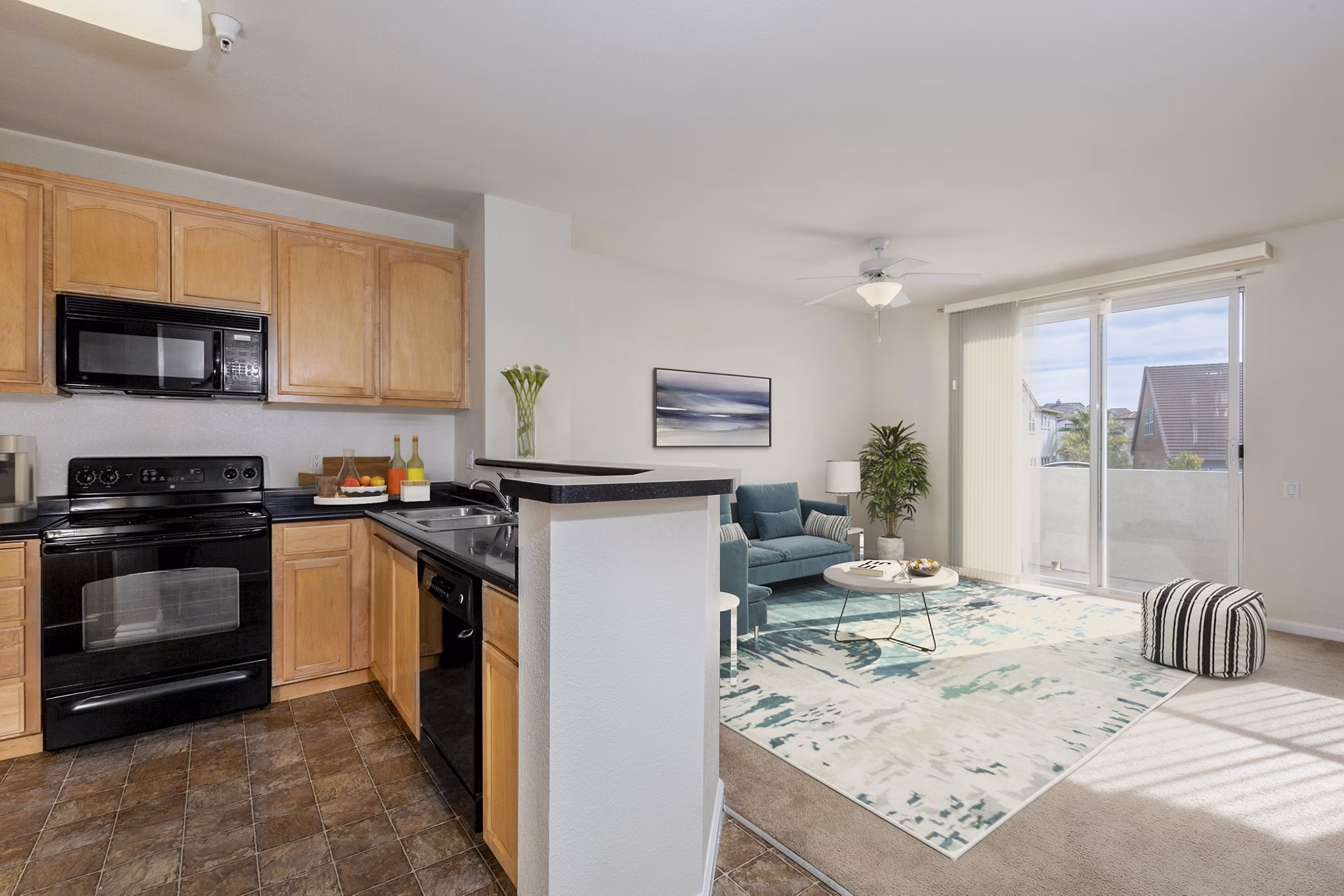 Modern kitchen with marble countertops and stainless steel appliances at Villas at Monterosso luxury apartments