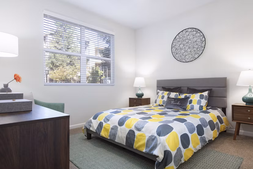 Peaceful bedroom with neutral tones and large windows at Morgan Park Apartments