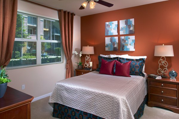 Peaceful bedroom with neutral tones and large windows at Morgan Park Apartments