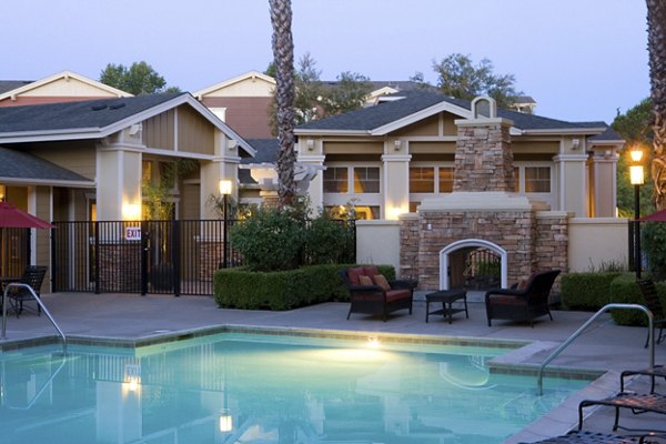 Resort-style pool with lounge chairs at Morgan Park Apartments, ideal for relaxation and social gatherings