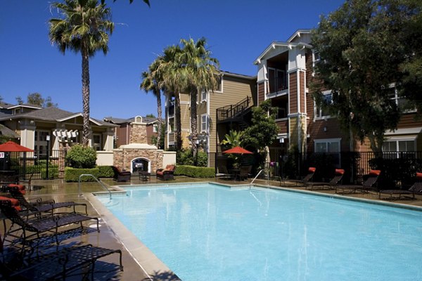 Outdoor swimming pool at Morgan Park Apartments, luxury apartments with landscaped surroundings and comfortable lounge chairs