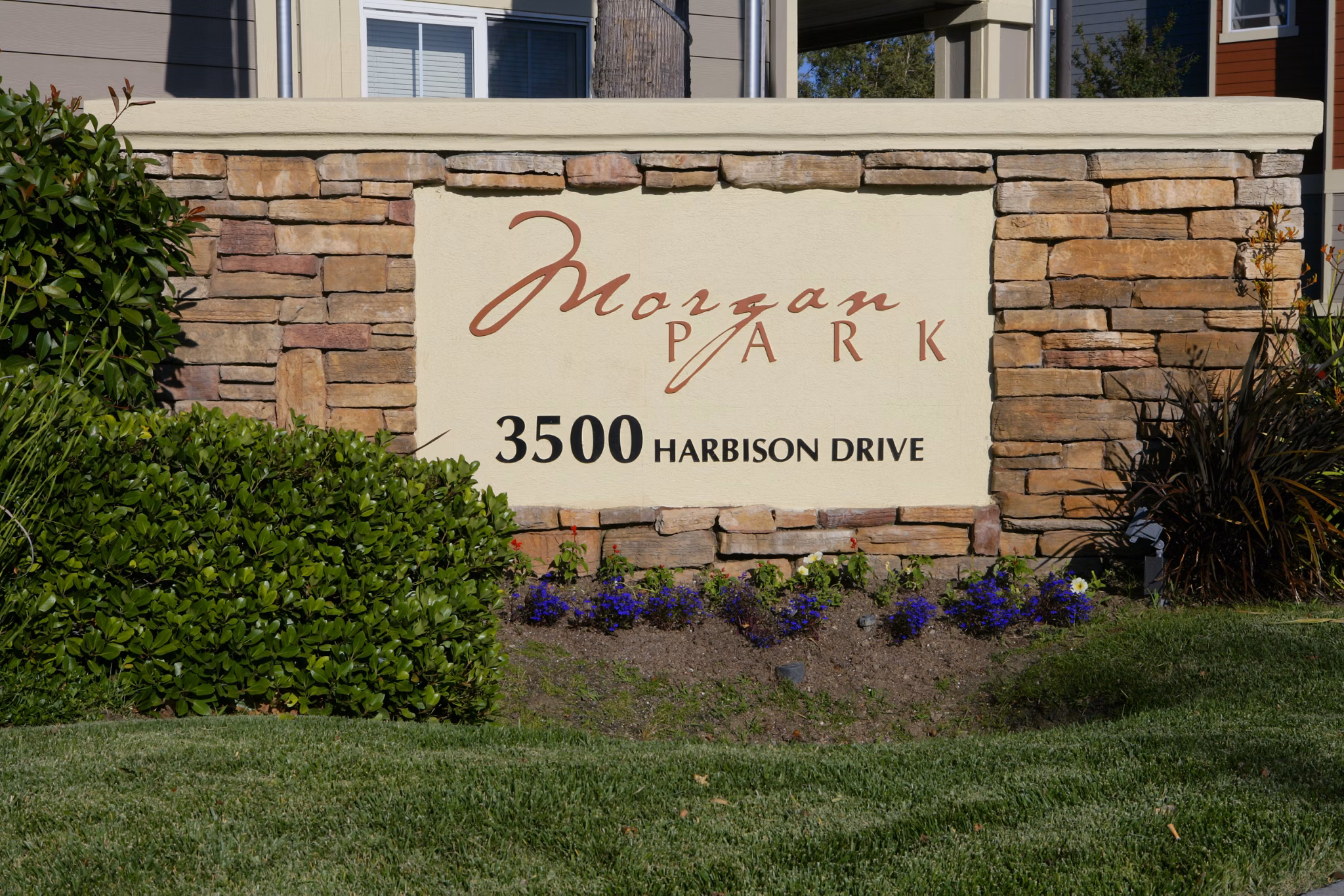 Morgan Park Apartments: Elegant property signage amidst lush greenery in a prime location