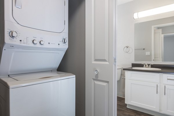 Laundry room with modern appliances at Autumn Springs Apartments, a Greystar luxury apartment community