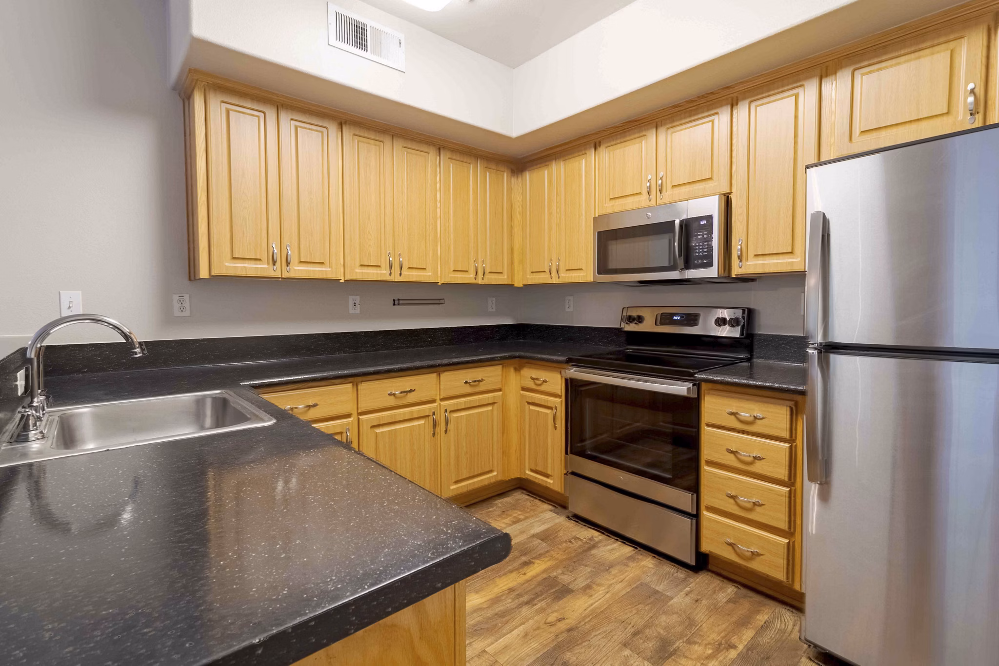 Park Place Apartments: Modern kitchen with sleek appliances and granite countertops