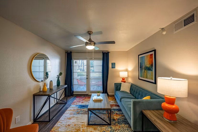 Spacious living room with modern decor and ample natural light in The Bella Apartments, a Greystar luxury property